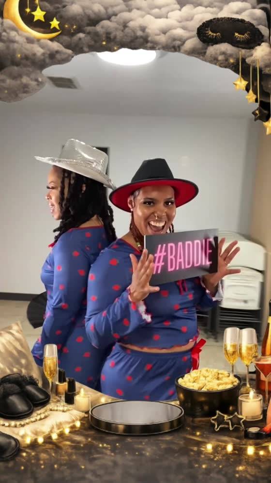 Two guests posing with props at a birthday party