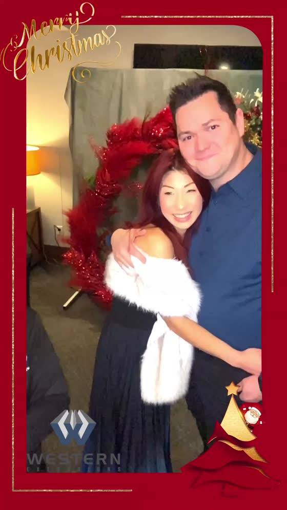 Couple at a company holiday party in a Christmas frame