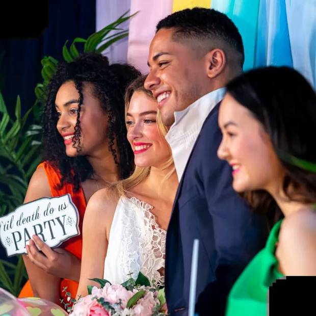 Bridal party posing with props