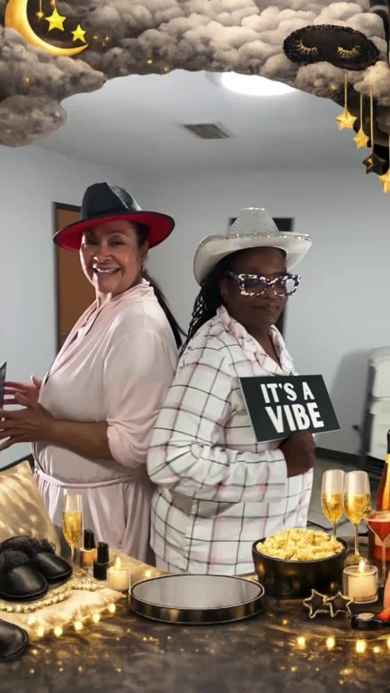Friends posing together with props at a B.A.D Photogenics booth